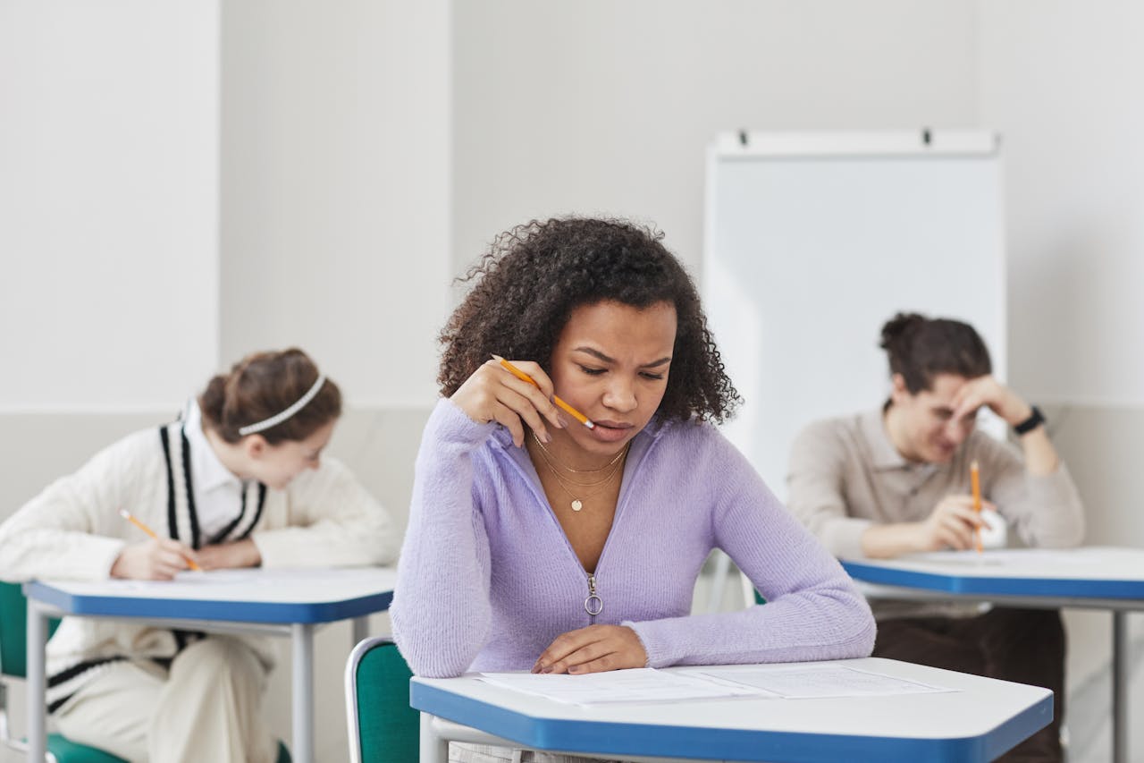 Focused students taking an exam in a classroom setting.